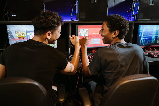 Two boys are playing online  games on computer